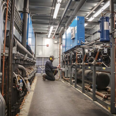 worker performing service on specialty refrigeration system