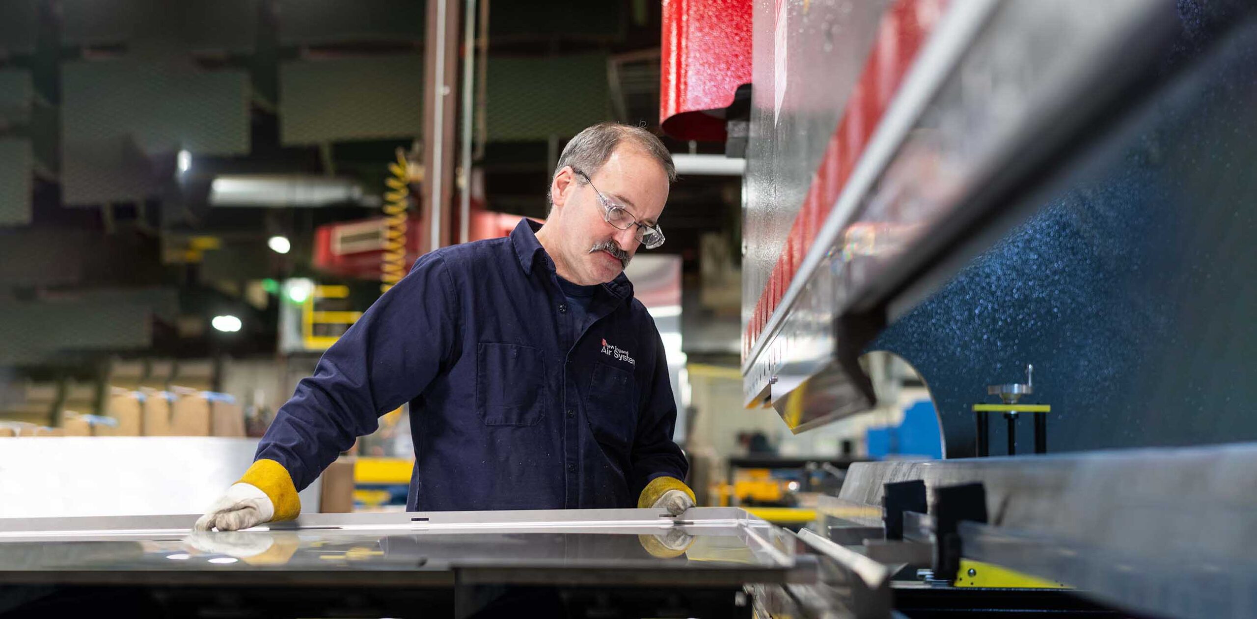 Worker at press brake