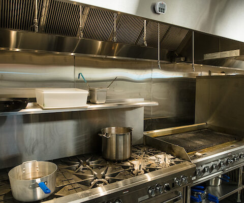 stainless steel hood ventilation system in commercial kitchen