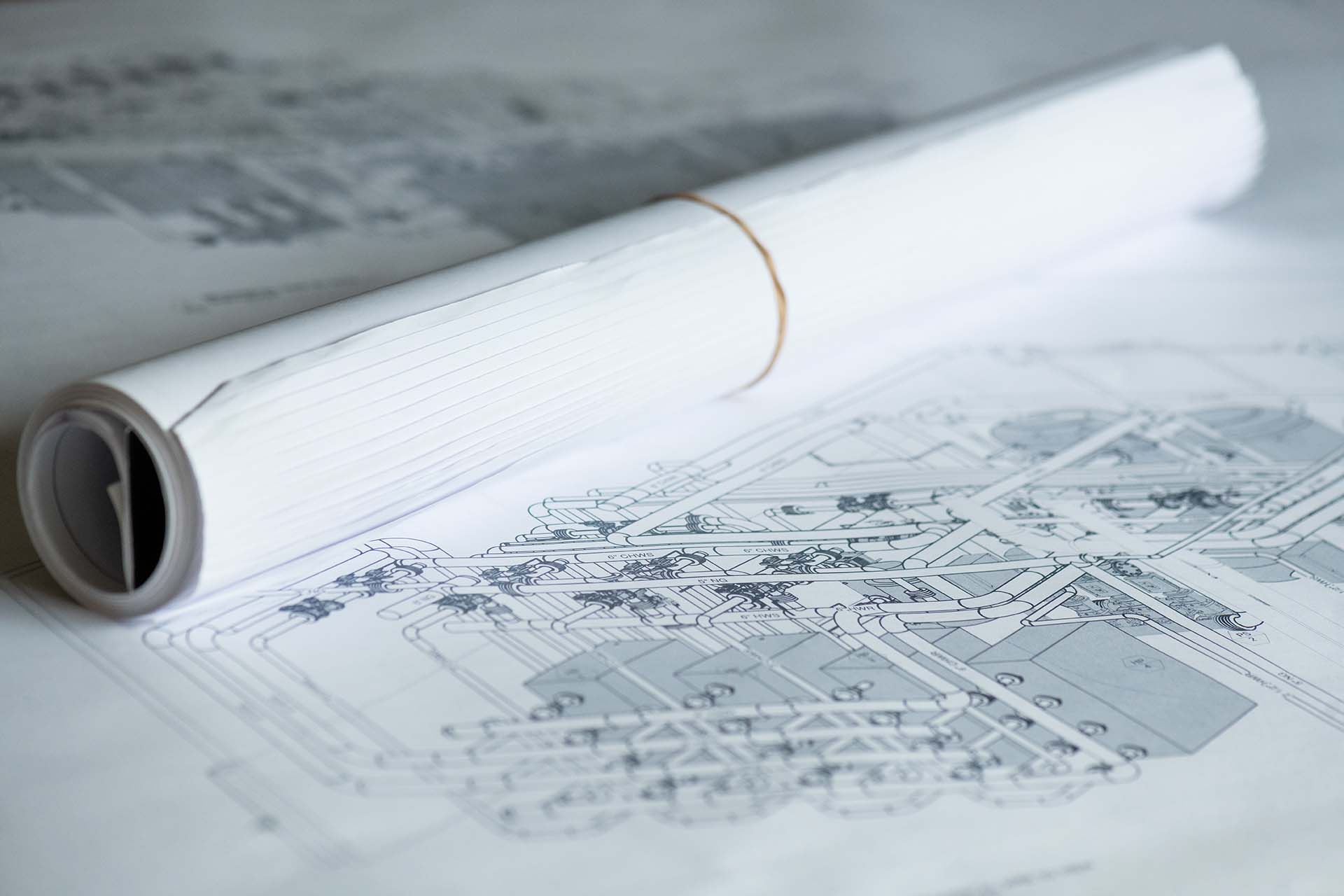 paper copy of HVAC and plumbing system design plans
